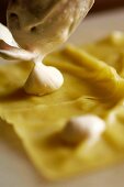 Ravioli being filled with cream cheese (close-up)