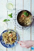 Spaghetti with green pesto, prawns, basil and parmesan