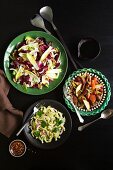 Assorted salads on a black background