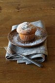 A muffin dusted with icing sugar