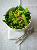 Mange tout salad with orange zest and hazelnuts