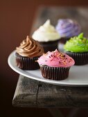 Cupcakes decorated with coloured frosting