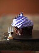 A cupcake decorated with lavender cream