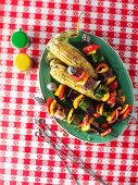 Barbecued vegetable skewers and corn on the cob
