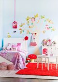 Little girl's room with a stylized tree painting on the wall
