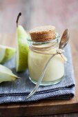 Pear and vanilla custard in a jar with a biscuit lid
