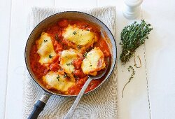 Chicken pieces with pancetta and mozzarella in tomato sauce
