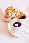 Hot chocolate with a marshmallow heart and biscotti for Valentine's Day