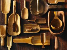Assorted wooden scoops on a wooden surface