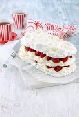 Coconut meringue cake with lime cream and raspberries