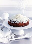 Frozen chocolate dome cake decorated with grated coconut