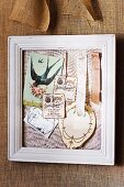 Fabric in white picture frame used as pinboard for romantic vintage decorations