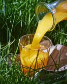 Orange juice being poured into a glass