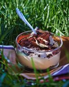 Tiramisu in a glass ramekin in the grass