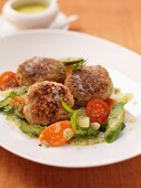 Veal meatballs with asparagus, carrots and tomatoes