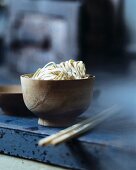 Oriental egg noodle in a wooden bowl