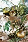 Christmas baubles and fir twigs in vintage copper bowl