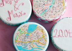 Wedding cakes topped with city maps of Munich and Hamburg