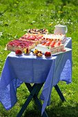 A splendid outdoor buffet of layer cakes