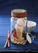 Cellophane noodles with ginger, chilli, peanuts and a small bottle of soy sauce in a screw-top jar