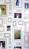 Souvenir photos arranged in picture frames of various sizes painted on interior wall