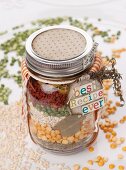 Assorted ingredients for soup in a screw-top jar as a gift