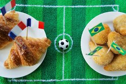 Croissants (France) and salgadinhos (Brazil) with football-themed decoration