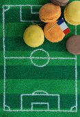 Macaroons (France) with a paper flag and football-themed decoration