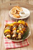 Barbecued skewers of loin pork, sweetcorn and shallots