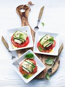 Sheep's cheese wrapped in courgette on slices of tomato