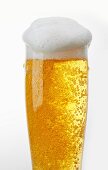 A glass of light beer with beer foam