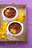 Chilli con carne with cubes of cheese, served with tortilla chips