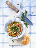 Ham cubes on a bed of vegetables with parsley