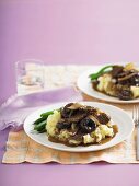 Pork with prunes on a bed of mashed potato