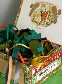 Colorful ribbons and cords in a vintage cigar box