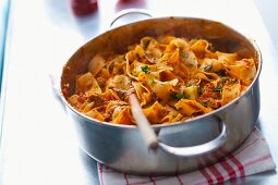 Pappardelle bolognese in a saucepan