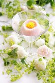 Wagashi in the shape of a camomile flower in a cocktail glass