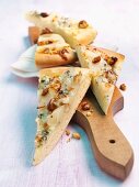 Triangles of bread topped with melted cheese and nuts