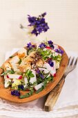 Radish salad with chicken, croutons and violets