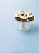 Frosted Cupcakes with Nut Topping on a Pedestal Dish