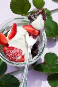 Chocolate pudding in a jar with strawberries and cream