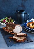 Crisp roast rack of pork with lemon potatoes and salad