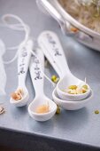 Assorted edible shoots on spoons
