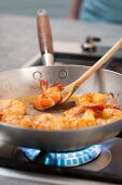 Pan Fried Shrimp in Skillet; Peels and a Glass of Beer