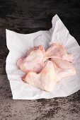 Chicken wings on baking parchment