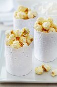Paper muffin cases wrapped in lace trim as creative popcorn holders