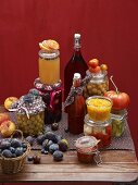 An autumnal still life featuring bottled vegetables and fruit