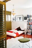 Stool and animal-skin rug & low bed on floor in modern bedroom