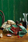 An Italian arrangement with bread, olive oil, tomatoes and red wine