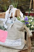 Hand-sewn shopping bag made from beige and pink linen and decorated with lace trim